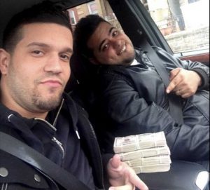 Photo credit: Handout | Elvis Rafael Rodriguez and Emir Yasser Yeje, both of Yonkers, are two of eight suspects in a cyber-hacking ring that stole $45 million in a few hours, the federal attorney in Brooklyn said. Investigators found this picture of the two suspects taken on a cellphone with $40,000 on the car seat. (May 9, 2013)